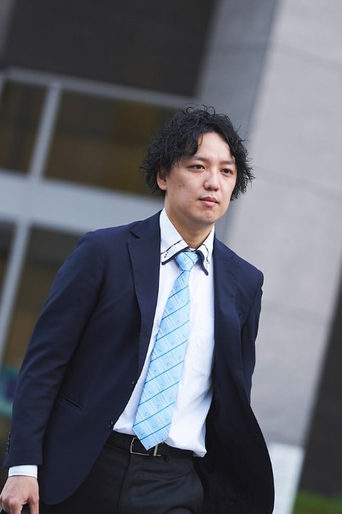 スーツ姿で歩く男性